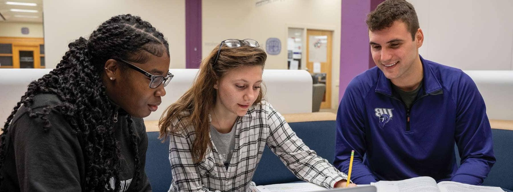 three students studying